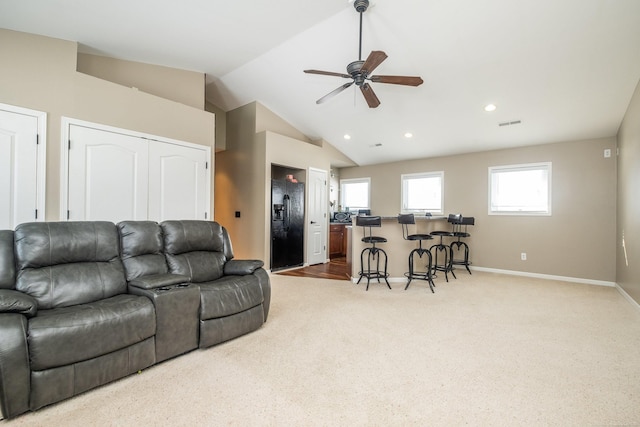 living room featuring lofted ceiling, carpet flooring, and ceiling fan