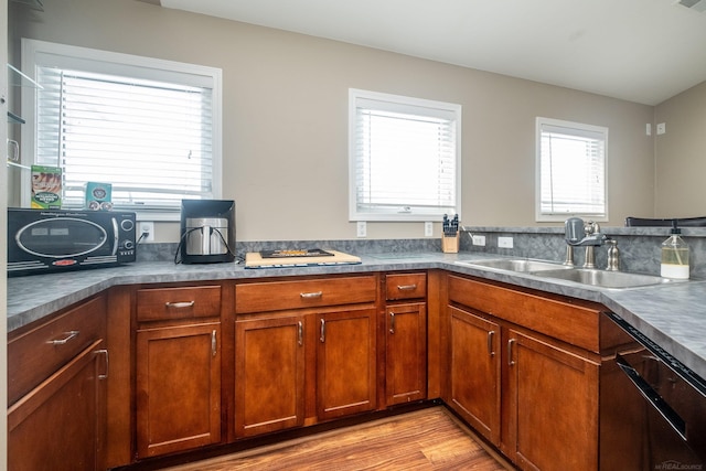 kitchen with white gas stovetop, dishwasher, sink, and light hardwood / wood-style flooring