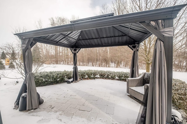 snow covered patio featuring a gazebo