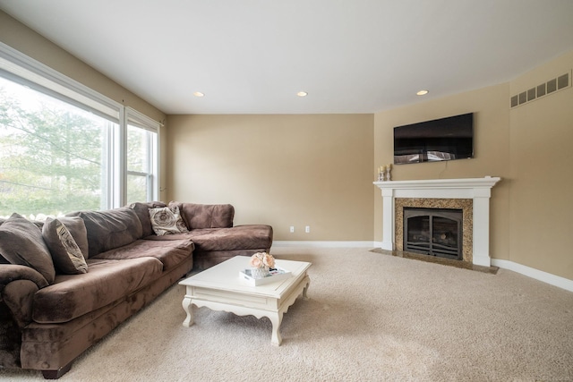 carpeted living room with a fireplace