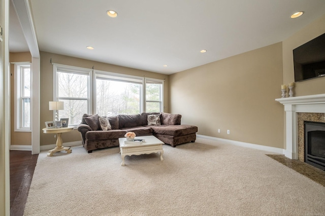 carpeted living room featuring a high end fireplace