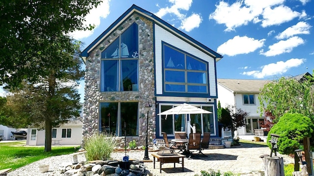 rear view of property featuring a patio area