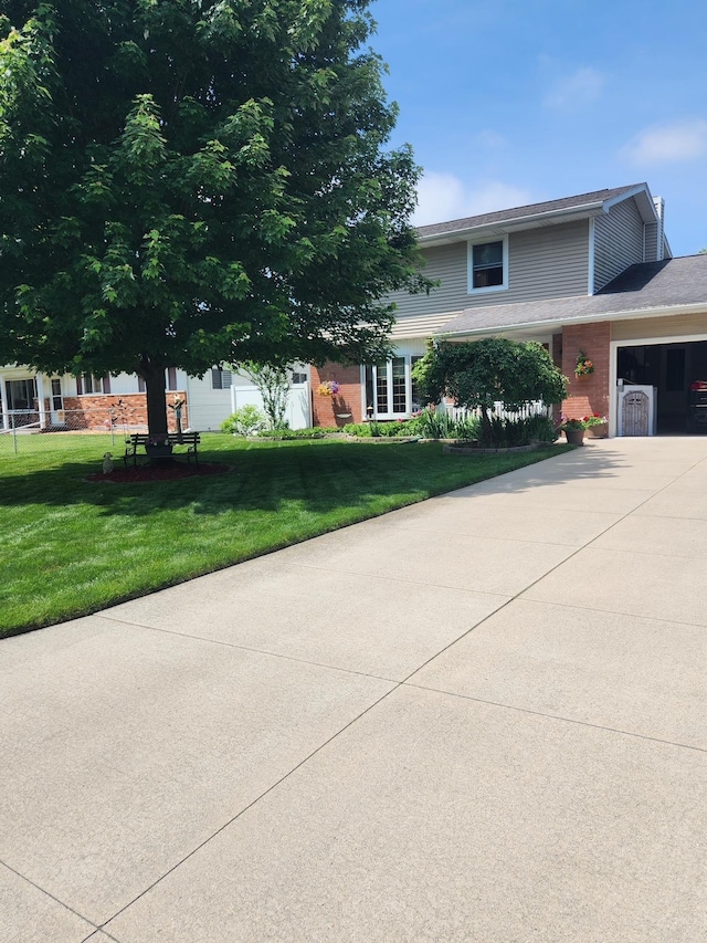 view of front facade with a garage and a front lawn