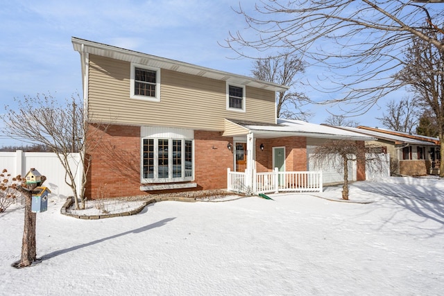 snow covered rear of property featuring a porch