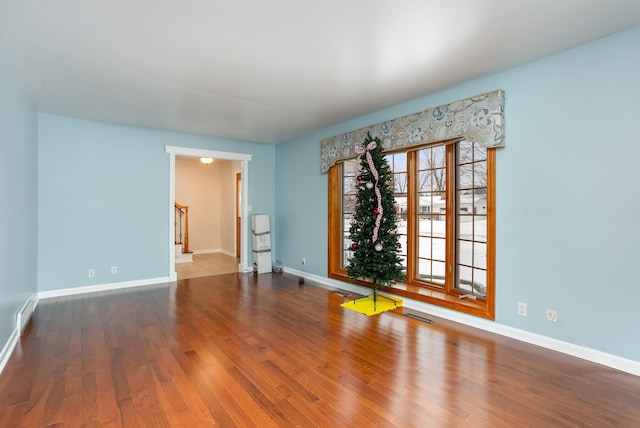 spare room featuring wood-type flooring