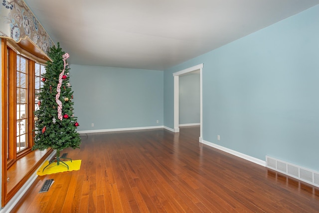 empty room featuring dark wood-type flooring