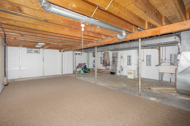 basement with electric panel and sink