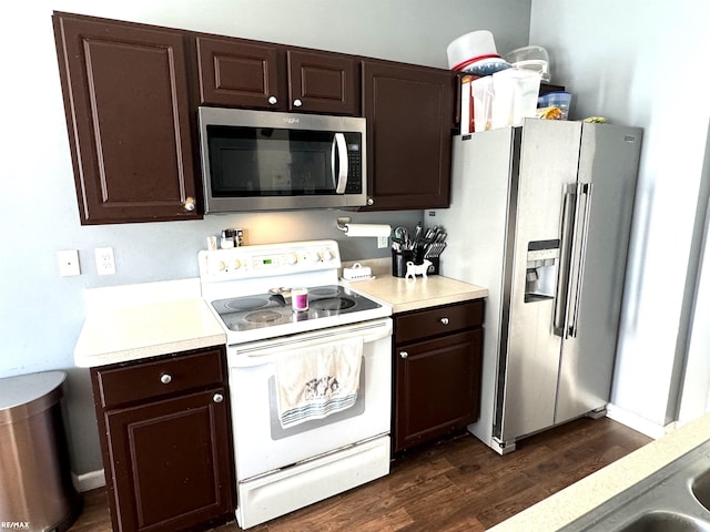 kitchen featuring dark brown cabinetry, stainless steel appliances, and dark hardwood / wood-style floors