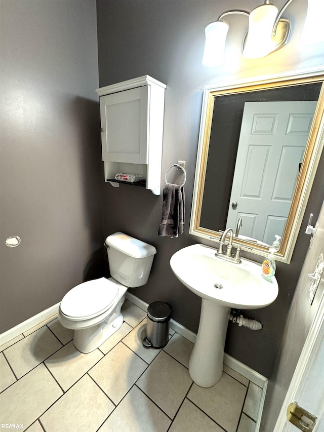 bathroom featuring toilet and tile patterned flooring