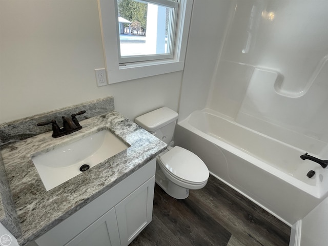 full bathroom featuring hardwood / wood-style flooring, vanity, shower / bath combination, and toilet