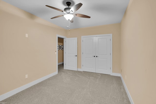 unfurnished bedroom with light carpet, ceiling fan, and a closet