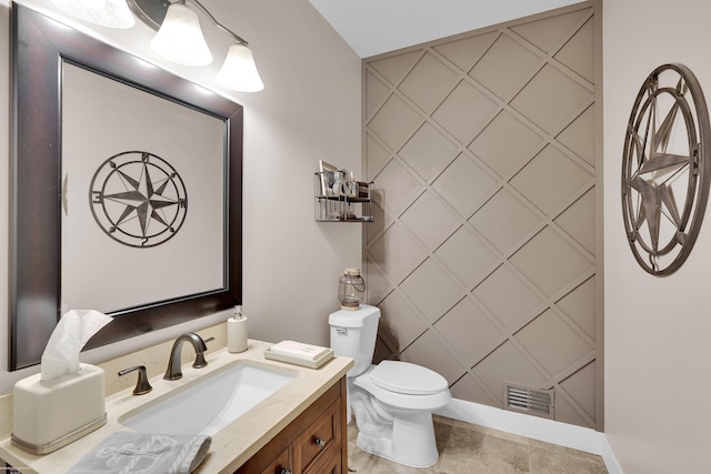 bathroom featuring tile patterned flooring, vanity, and toilet