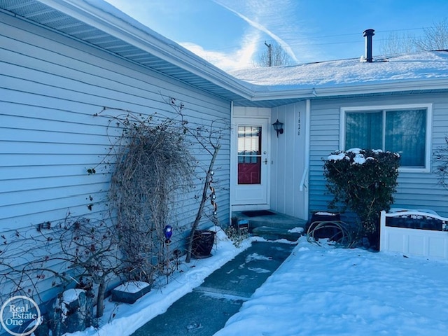 view of snow covered property entrance