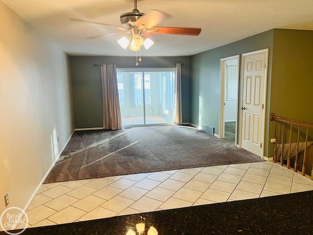 unfurnished room with ceiling fan and light colored carpet