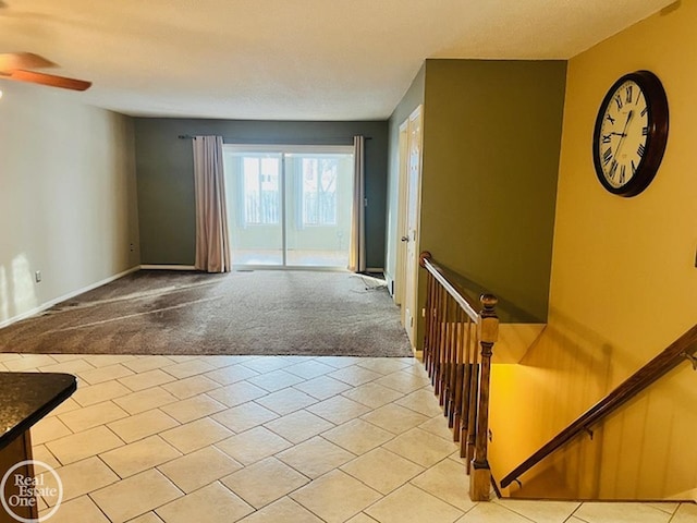 interior space with light colored carpet and ceiling fan