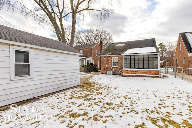 yard layered in snow featuring central air condition unit