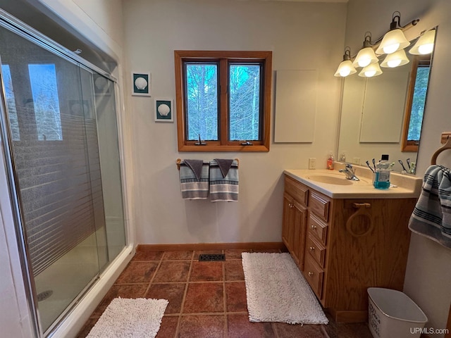 bathroom with vanity, tile patterned flooring, and a shower with door