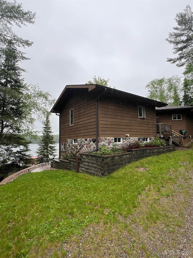 view of side of home with a lawn