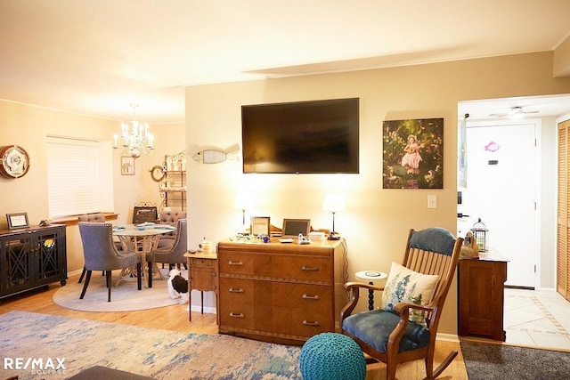 living room with an inviting chandelier and light hardwood / wood-style floors