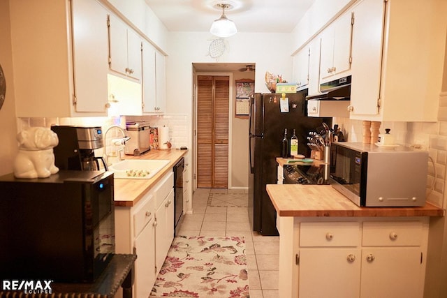 kitchen with black appliances and white cabinets