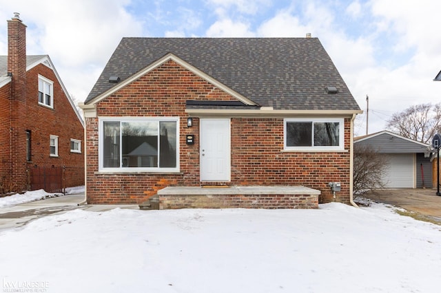 view of front facade featuring a garage and an outdoor structure