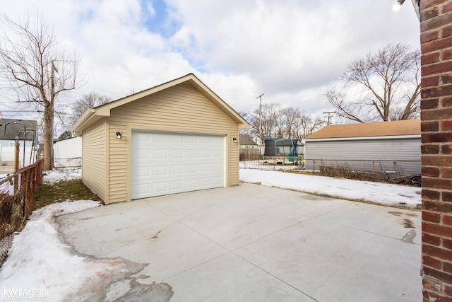 snow covered garage featuring a trampoline