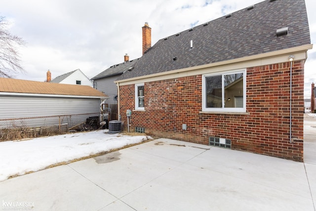 rear view of house featuring central AC and a patio