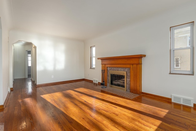 unfurnished living room with a high end fireplace and wood-type flooring