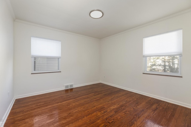 spare room with crown molding and dark wood-type flooring