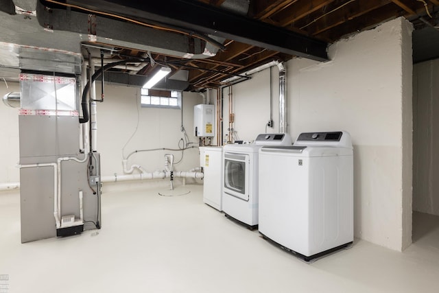 laundry room featuring heating unit, independent washer and dryer, and water heater