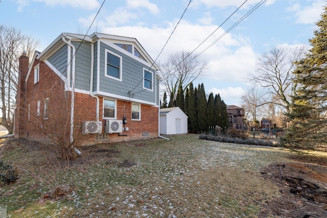 view of home's exterior featuring a storage shed, ac unit, and a lawn