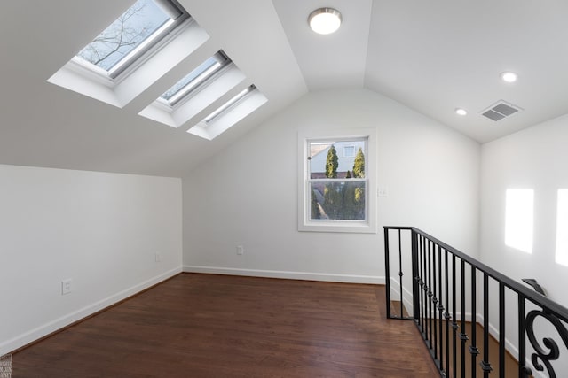 bonus room featuring lofted ceiling and dark hardwood / wood-style flooring