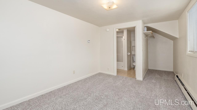 unfurnished bedroom featuring a baseboard radiator and light colored carpet