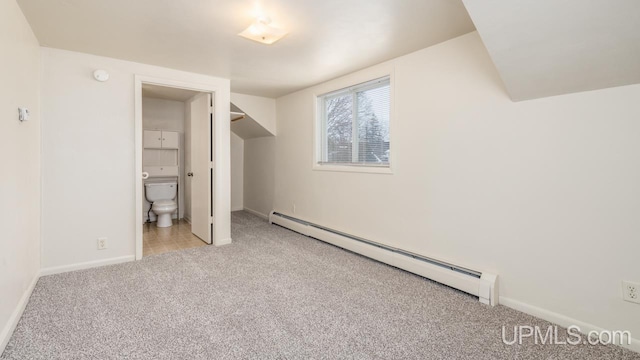 unfurnished bedroom featuring light carpet, ensuite bathroom, and baseboard heating