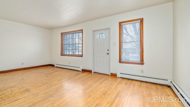 foyer with a baseboard heating unit and light wood-type flooring