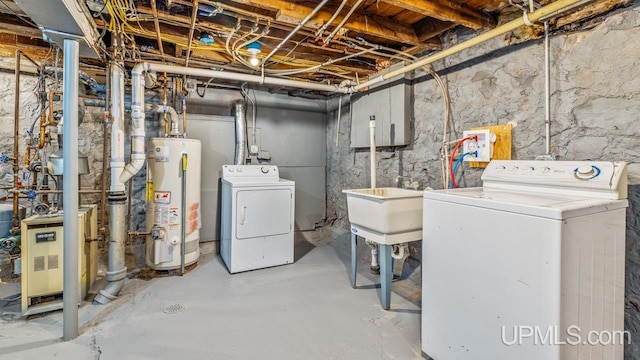 basement featuring water heater and washer and clothes dryer