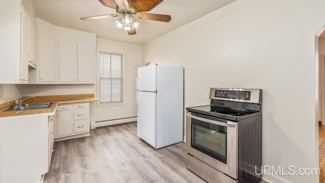 kitchen featuring sink, white cabinetry, stainless steel range with electric stovetop, a baseboard radiator, and white fridge