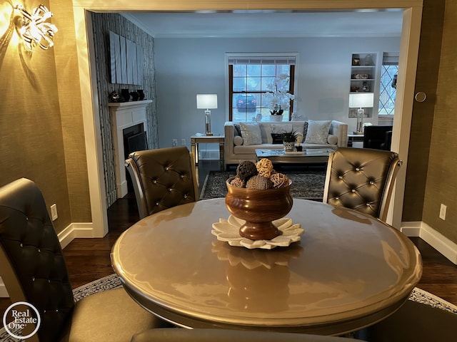 dining room featuring ornamental molding and dark hardwood / wood-style flooring