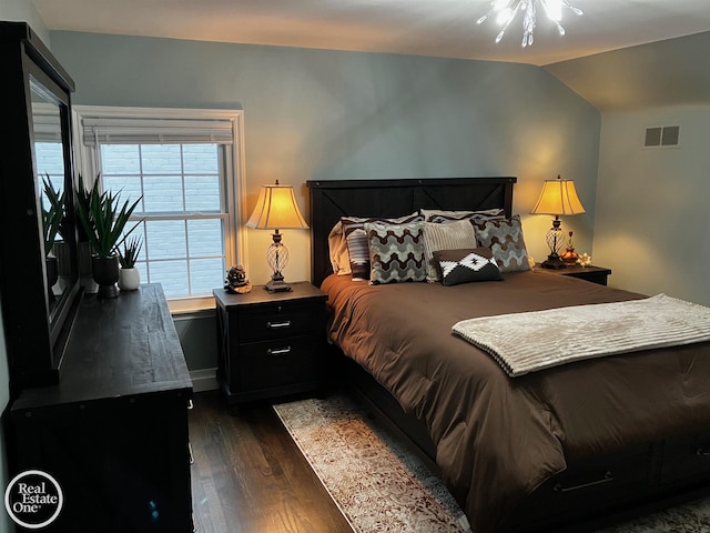 bedroom featuring lofted ceiling and dark wood-type flooring