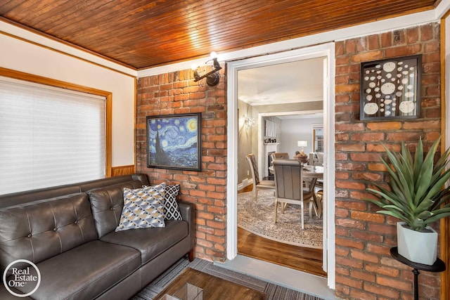 living room with hardwood / wood-style flooring, ornamental molding, and wood ceiling