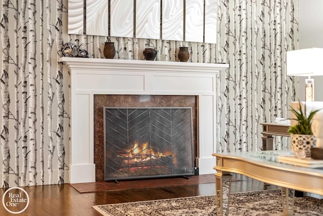 room details featuring a tile fireplace and wood-type flooring