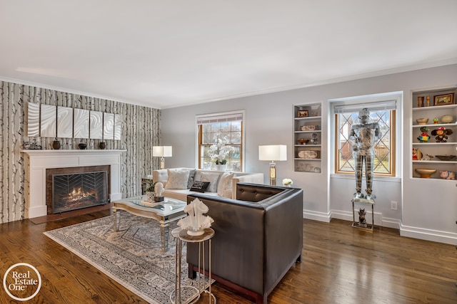 living room featuring crown molding, dark hardwood / wood-style flooring, and built in shelves