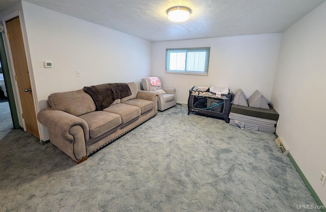 carpeted living room featuring a textured ceiling