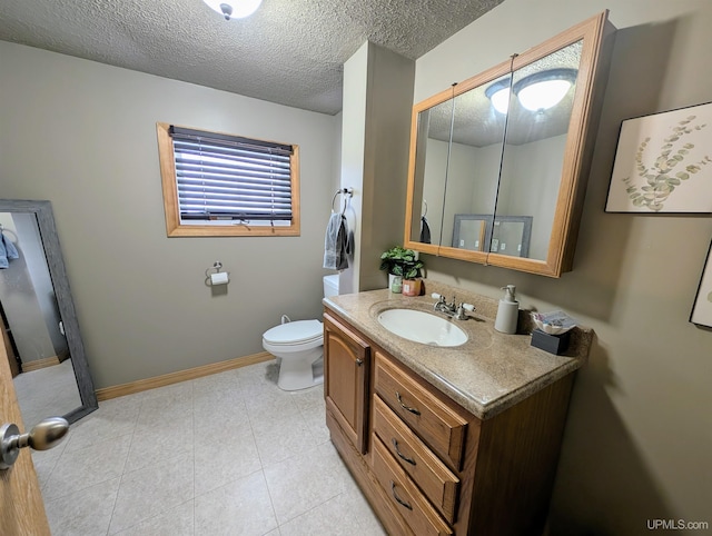 bathroom featuring vanity, toilet, tile patterned flooring, and a textured ceiling