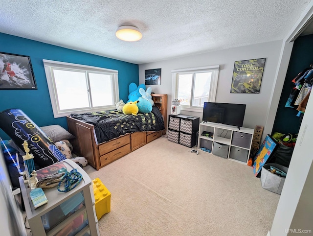 bedroom featuring carpet and a textured ceiling