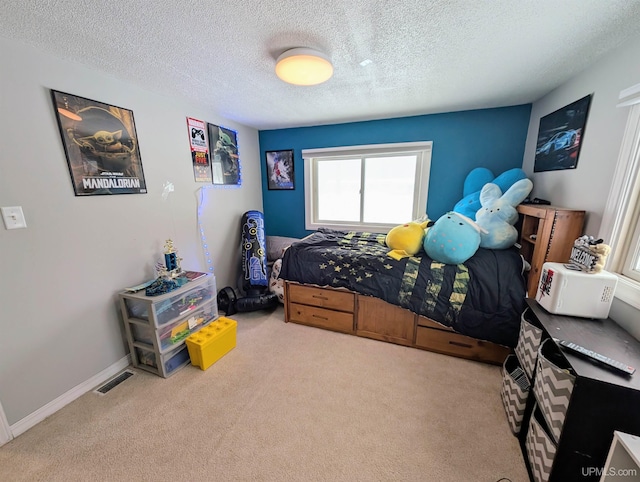 carpeted bedroom with a textured ceiling