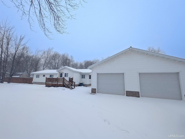 view of front of property featuring a garage and a deck