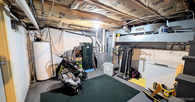 basement featuring gas water heater and refrigerator