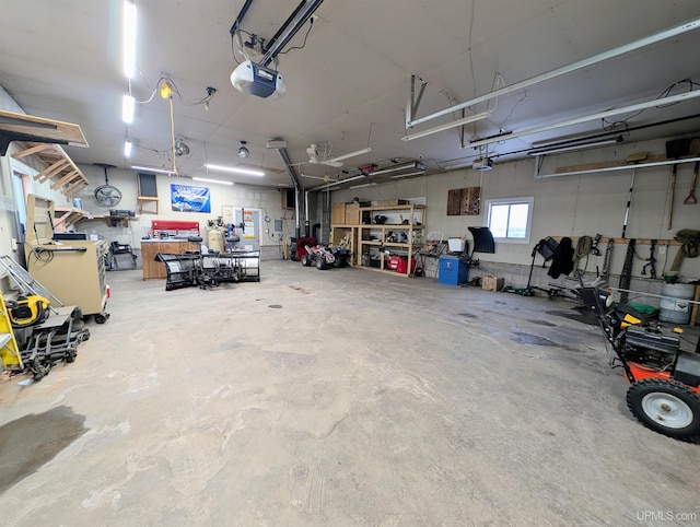 garage featuring a garage door opener and a workshop area