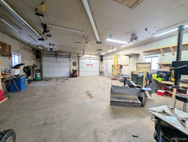 garage with a garage door opener and a workshop area